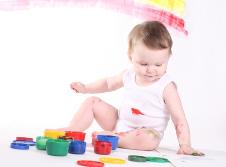 little girl bedaubed with bright colorsの写真素材