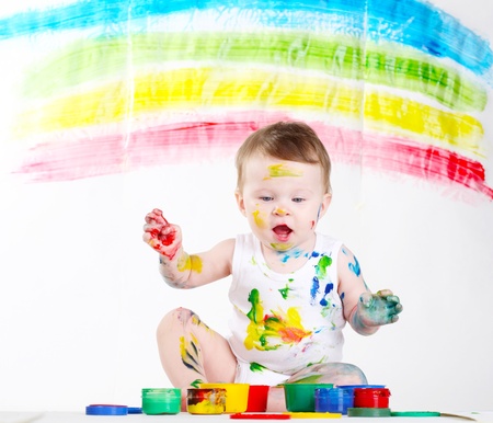 little girl bedaubed with bright colorsの写真素材