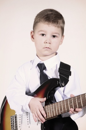 little boy with an electroguitar in hands.の写真素材