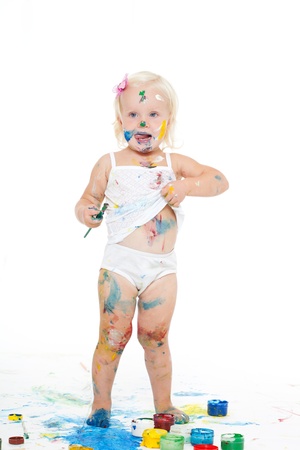 little girl bedaubed with bright colorsの写真素材