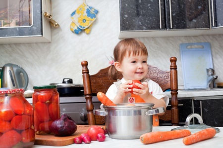 little girl helps to make a dinnerの写真素材