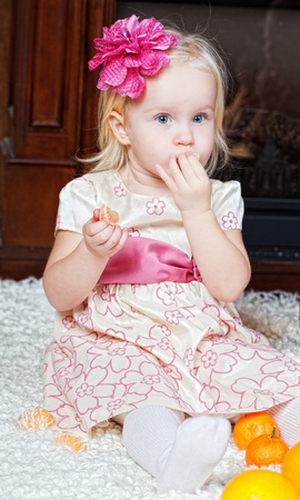 little girl at a Christmas fir-treeの写真素材