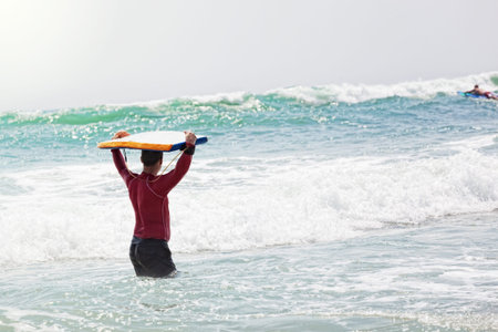 male athlete goes to go for a drive on surfの写真素材