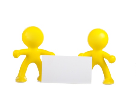 Two yellow little men hold a white banner with a place for the textの写真素材