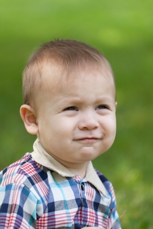 Portrait of the malenoky boy against a green grassの写真素材