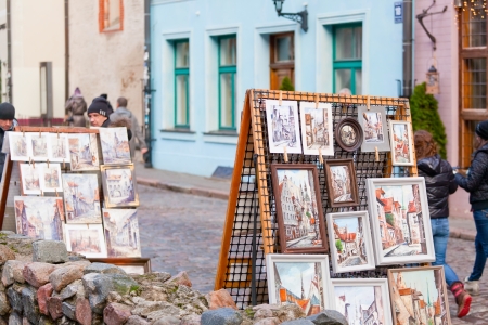 RIGA, LATVIA - DECEMBER 30, 2013: Pictures of sidewalk artists. Threshing barn capital of Latvia and the largest city of the countries of Baltic with population of 695 539 peopleのeditorial素材