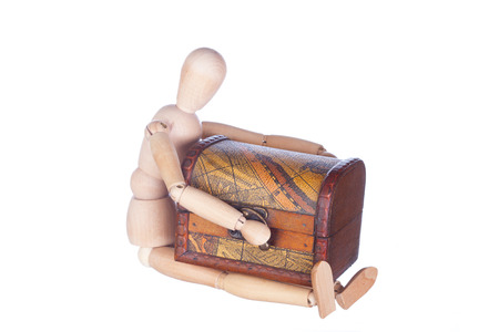 sitting wooden dummy holds a chest, is isolatedの写真素材