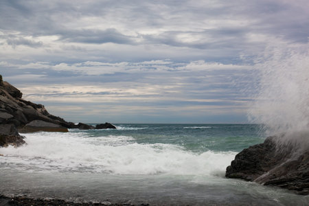 Waves break about stones, the Liguriysky coast, Italy