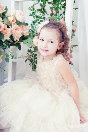 beautiful girl in an elegant dress with flowersの写真素材