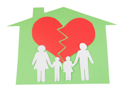 Divorce effect on kids concept with hands cutting paper people familyの写真素材