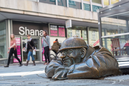 BRATISLAVA, SLOVAKIA - APRIL 16,2016. Cumil - statue of man peeking out from under a manhole cover . Popular attraction was made in 1997 by sculptor Viktor Hulik.のeditorial素材
