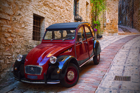 ITALY, SPELLO - SEPTEMBER 29, 2015: Old ÑÐµÐ´ Citroen to stand near a wallのeditorial素材