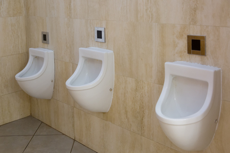Three urinals in a man's toiletの写真素材