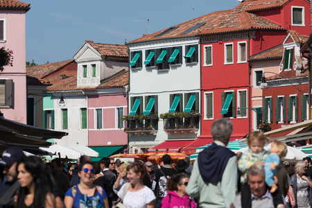 ITALY, BURANO - SEPTEMBER 26, 2017: A crowd of tourists on the island of Burano, Venice on a sunny dayのeditorial素材