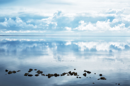 Clouds are reflected in the water of the salt lake of Elton, Russiaの写真素材