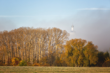 Bogolyubovo autumn. Behind the trees in the fog visible domes of the Bogolyubovo monastery. Vladimir region, Russiaの写真素材