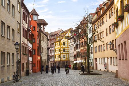 GERMANY, NURNBERG - DECEMBER 20, 2018: People walk the streets of the Old Town in Nuremberg on a sunny dayのeditorial素材