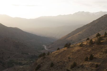 Mountain range and the road at sunset, Uzbekistanの写真素材