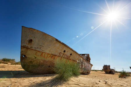 UZBEKISTAN, MUYNAK - SEPTEMBER 19, 2019: Old rusty ships in the place where the Aral Sea used to beのeditorial素材
