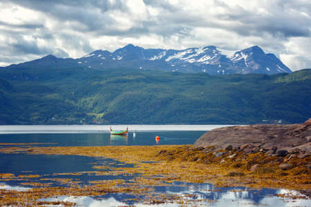 Norway. Landscape with fjord, boat and mountains on a summer dayの写真素材