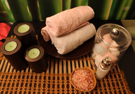Spa still-life with candles, sea salts, towel, on bamboo backgroundの写真素材