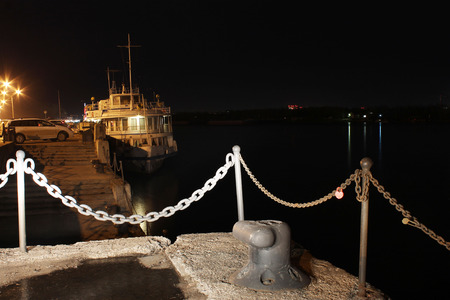 Motor ship standing on the river at nightの写真素材