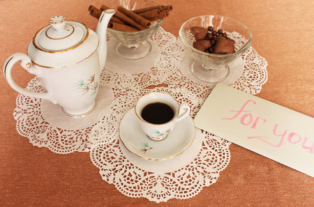 Still Life with cup of coffee, coffee pot, vase with sweets, on the lace salfeteの写真素材