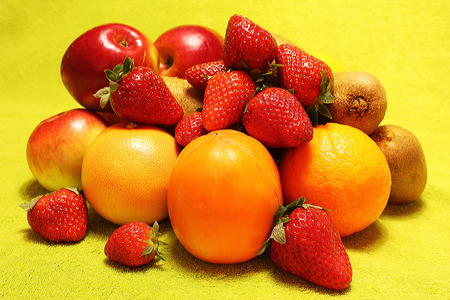 Still life of fruits, apples, strawberries, kiwi, orange, grapefruit, tangerine, persimmon, plumの写真素材