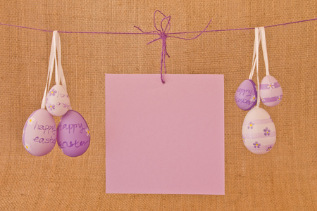 Eggs with violet flowers and a congratulatory sheet hanging on a ropeの写真素材