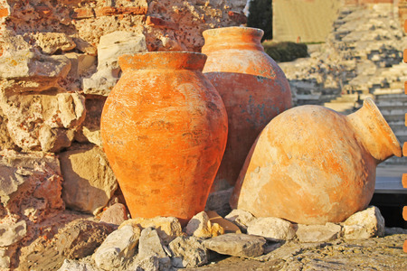 Three antique amphoras of clay on the background of the ruinsの写真素材