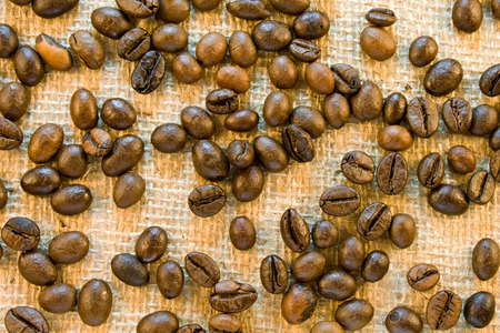 Frame made of roasted brown coffee beans on a sackingの写真素材