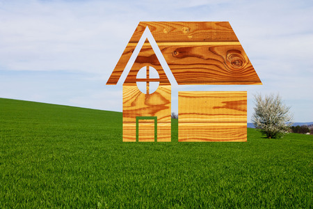 House drawn on a background of grass blue sky and blossoming treeの写真素材