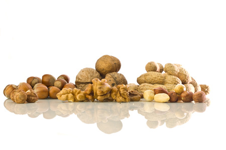 Walnuts, hazelnuts and peanuts with reflection on white isolated  backgroundの写真素材