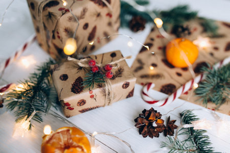 Christmas gifts, lollipop, tangerine on white wooden backgroundの写真素材