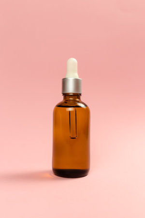Bottle of cosmetic oil on pink backgroundの写真素材