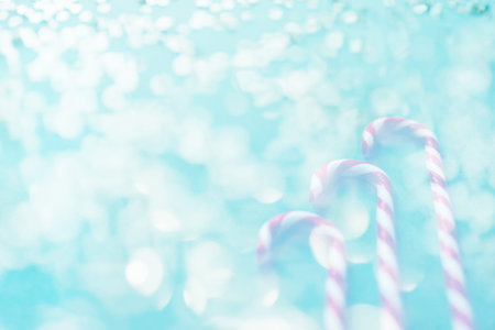 Christmas candies on blue background, red white lollipop