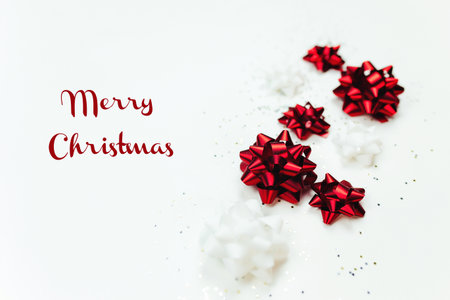 Christmas background with red and white bows and glitterの写真素材