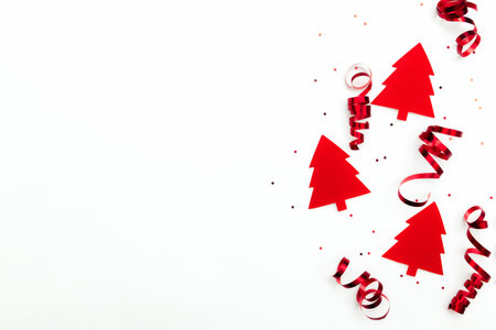Christmas trees with red ribbons and glitter stars on white backgroundの写真素材