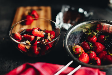 Cooking ingredients strawberry, chocolate, walnuts on the tableの写真素材