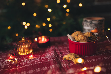 Christmas cookies and candles, christmas tree and lightsの写真素材