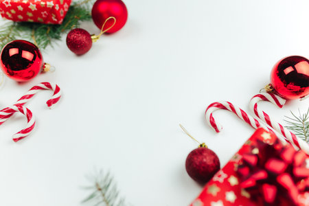 Red christmas decoration on white background, Christmas gifts, candies, lollipopの写真素材