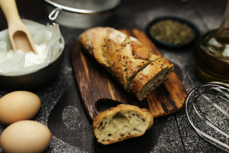 Fresh baked bread and baking ingredients on a tableの写真素材