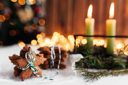 Christmas decorations with candles, fir branches and gingerbread