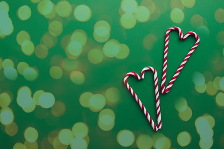 Christmas candies on green background, red white lollipopの写真素材