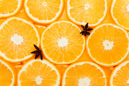 Background with orange slices, oranges texture, citrus and aniseの写真素材