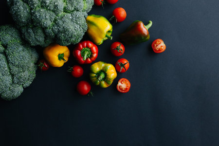 Fresh green broccoli and other vegetables, drops of water on broccoli. Gray background
