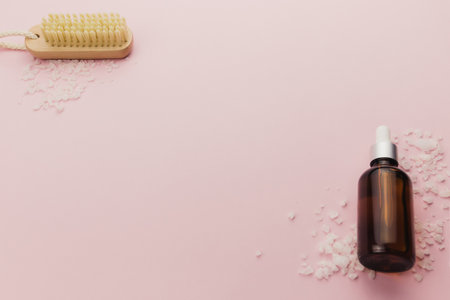 Bottle of cosmetic oil and brush on pinkの写真素材