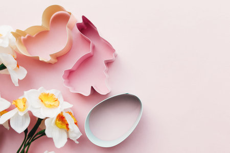 Spring Narcissus, bunny, egg, bird Easter form for baking. Pink background. High quality photo