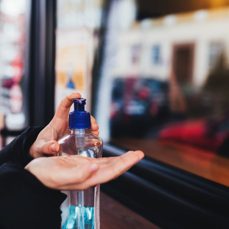 Using of sanitizer before entering the cafe. Blurred background