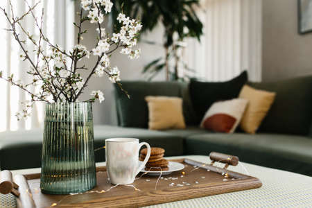 Home interior. Cookies, coffee. Apple tree color has flown. Blurred background. High quality photoの写真素材